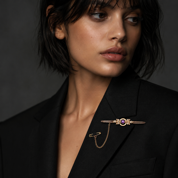 antique purple gold brooch on model wearing blazer