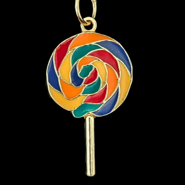 Colorful lollipop charm on a black background
